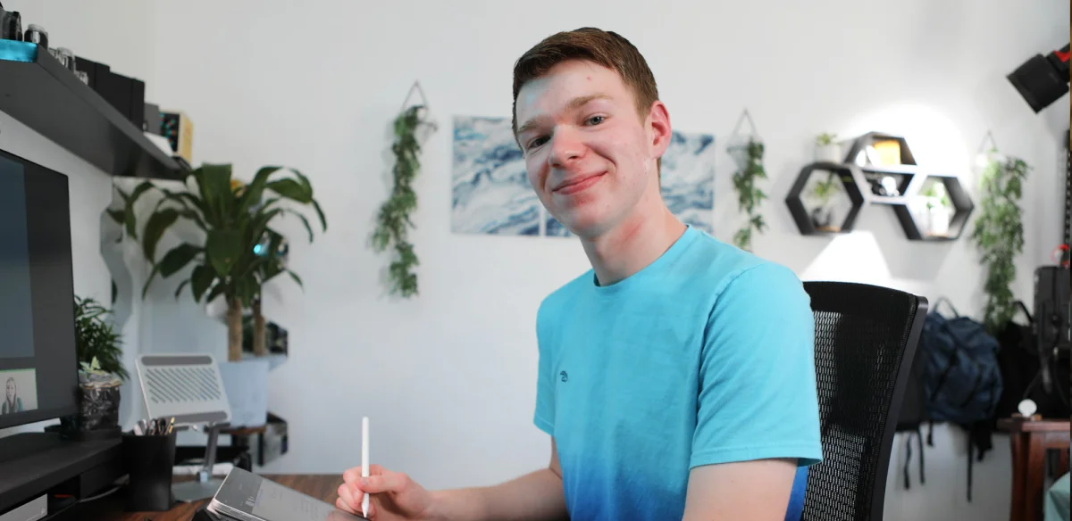 High school student wearing a light blue shirt and taking notes