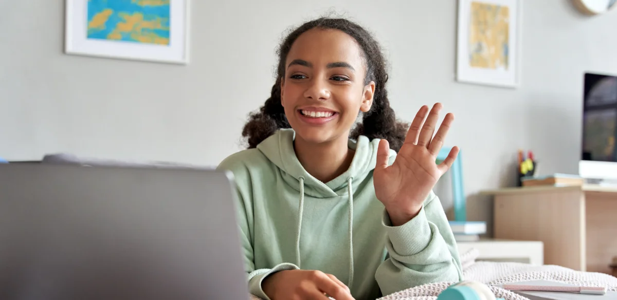 High School student wearing a light green hoodie at home