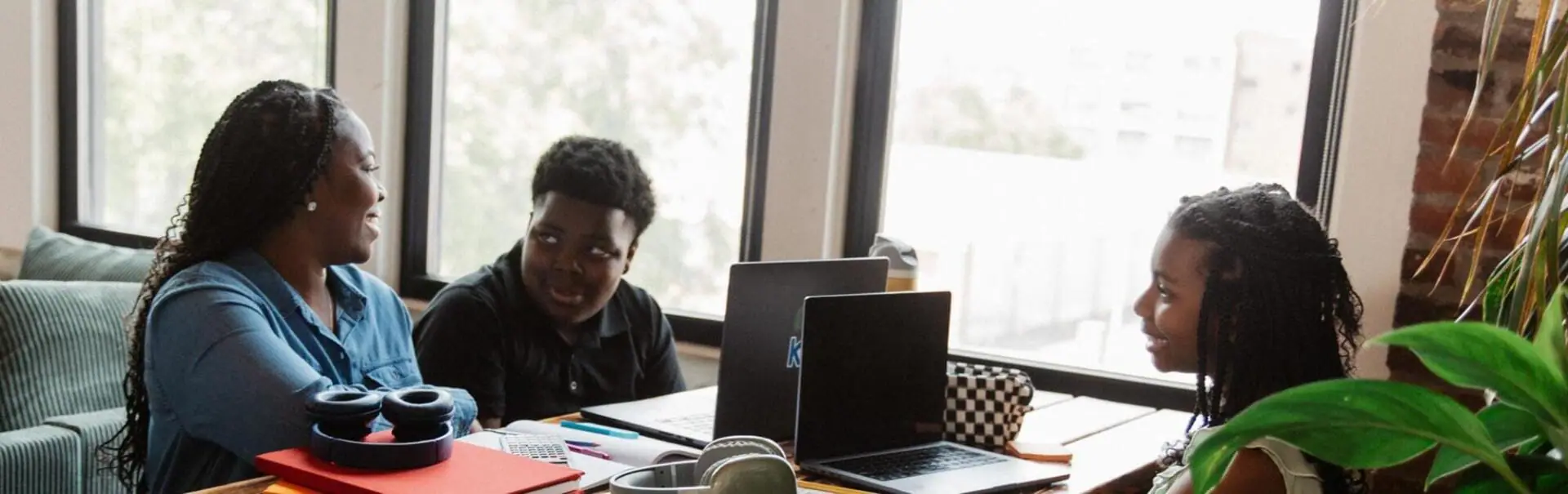 Mother and her children working together at home with their laptops